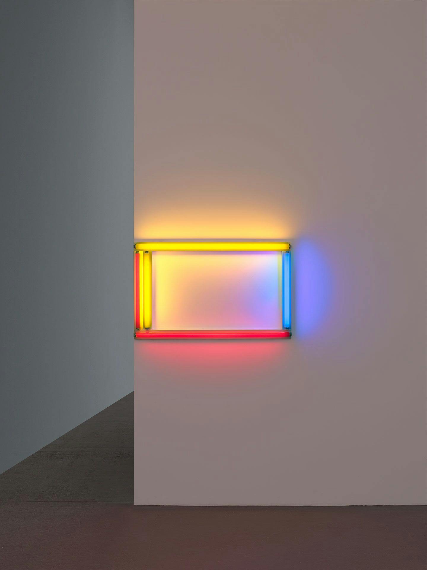A sculpture in red, yellow, and blue fluorescent light by Dan Flavin, titled a primary picture, dated 1964.